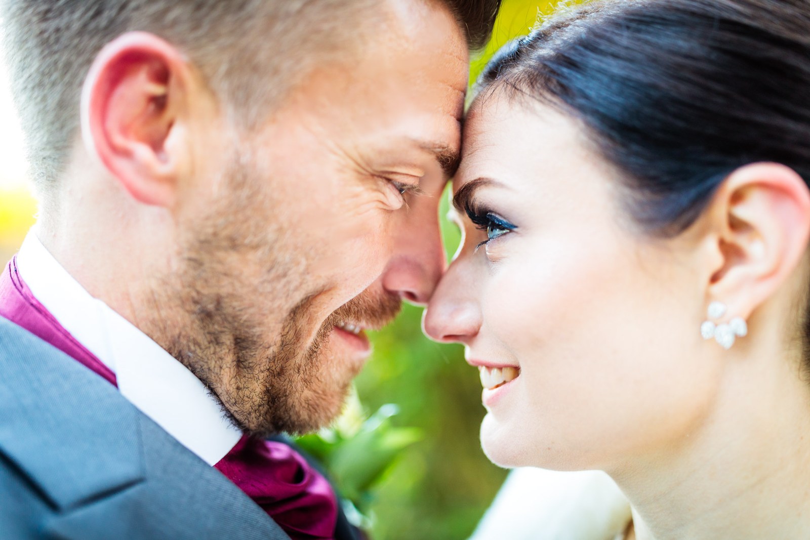 The newlyweds rest their foreheads together in soft evening light