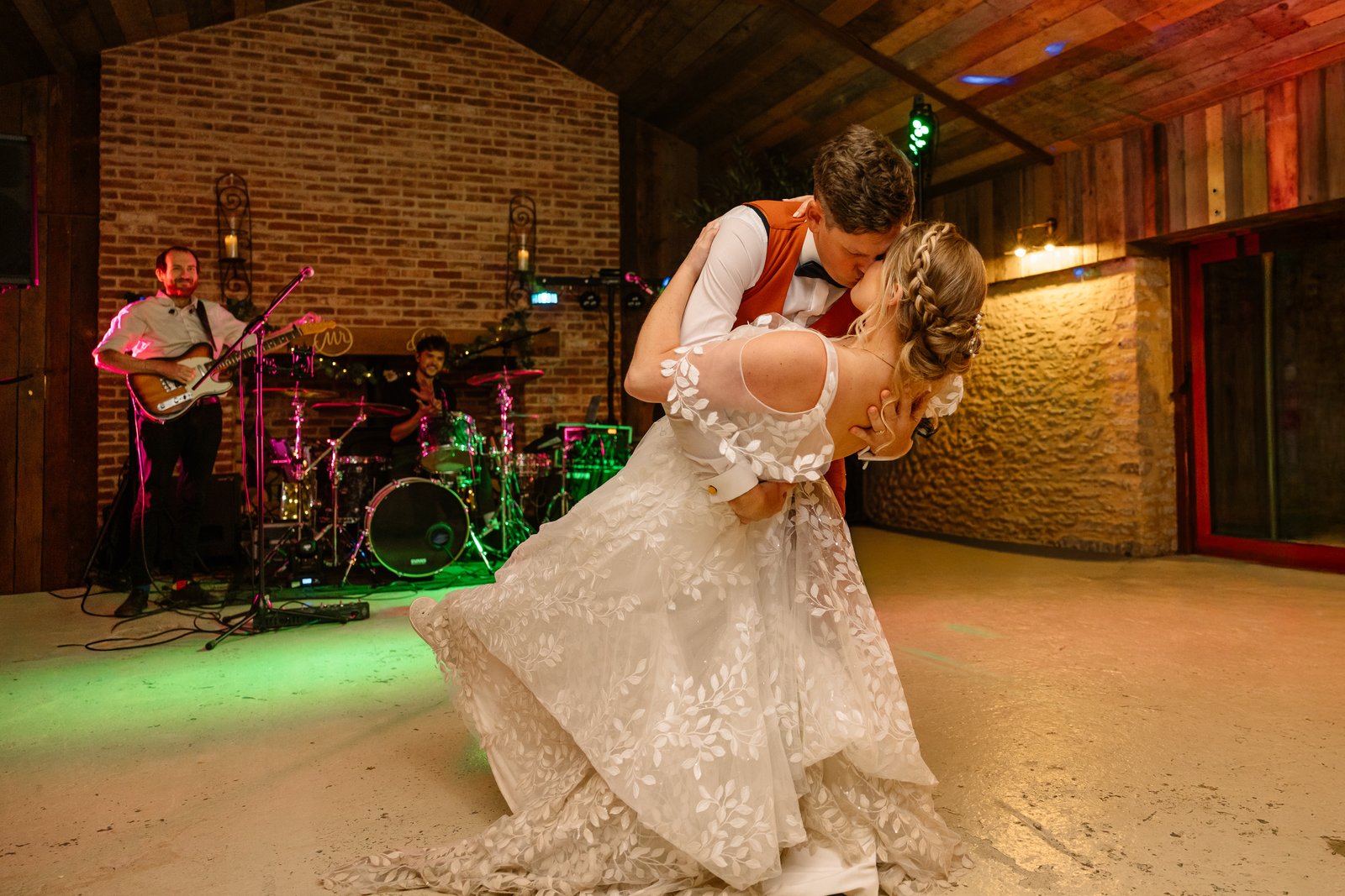 The bride's dress swinging out as the couple dance in front of the live band.