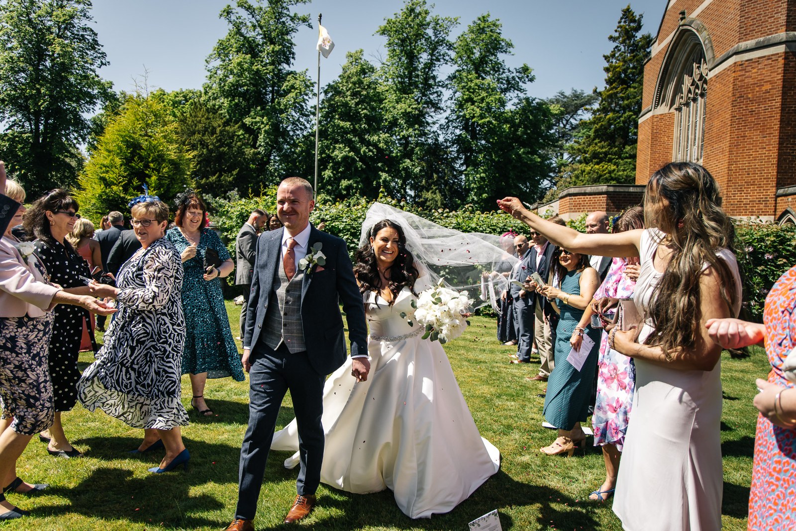 The couple showered with confetti on the lawn outside the church