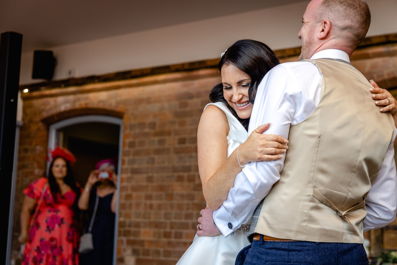 Bride and groom sharing their first dance in the doorway at Swallows Nest Barn