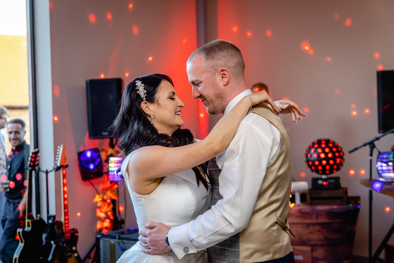 The couple's first dance beneath disco lights at Swallows Nest Barn