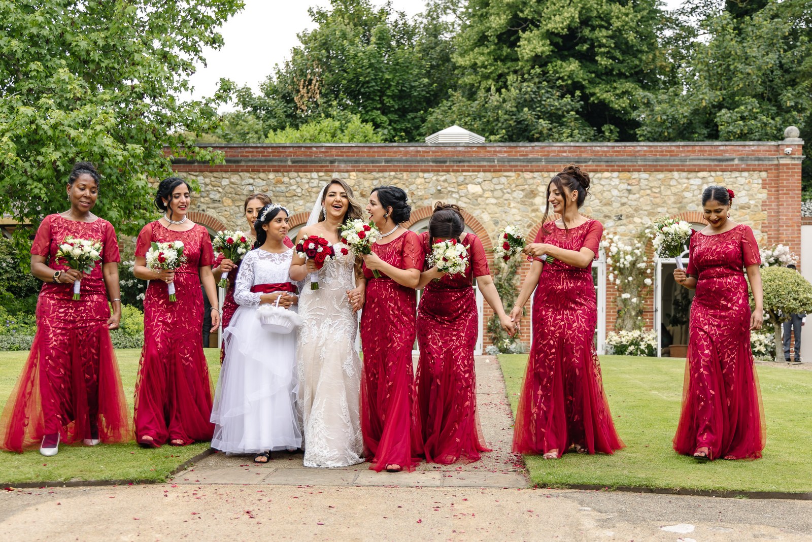 The bride, bridesmaids and flower girl in the walled garden at The Orangery