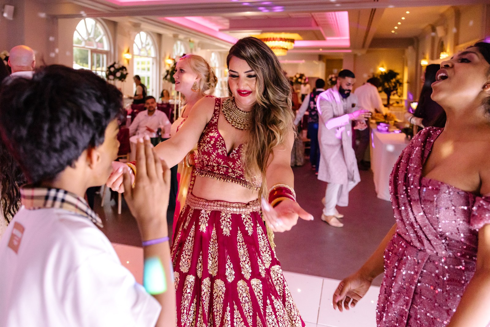 The bride dancing with guests on the reception floor