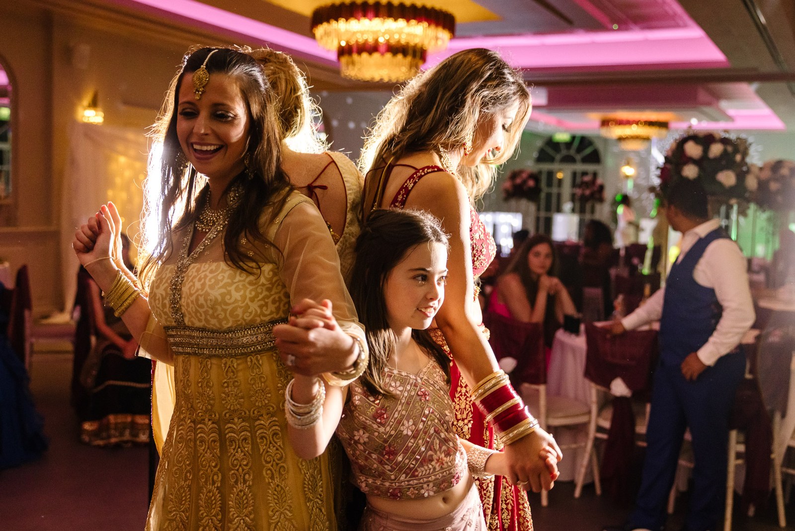 Female guests and children dancing together at the reception