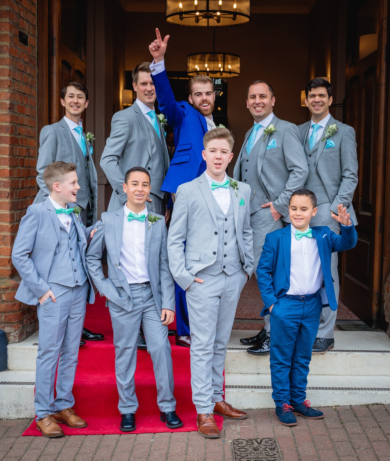 The groom with his groomsmen and page boys posed on the Villiers Hotel entrance steps