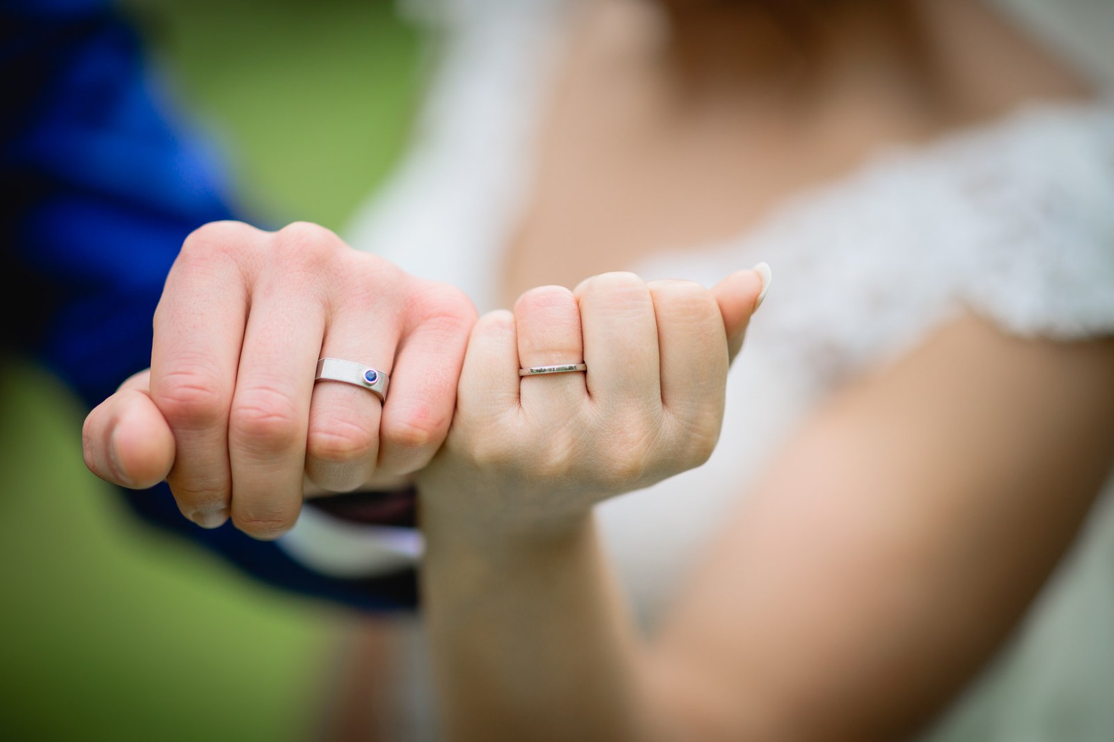 Close-up of the couple's hands showing their new wedding rings