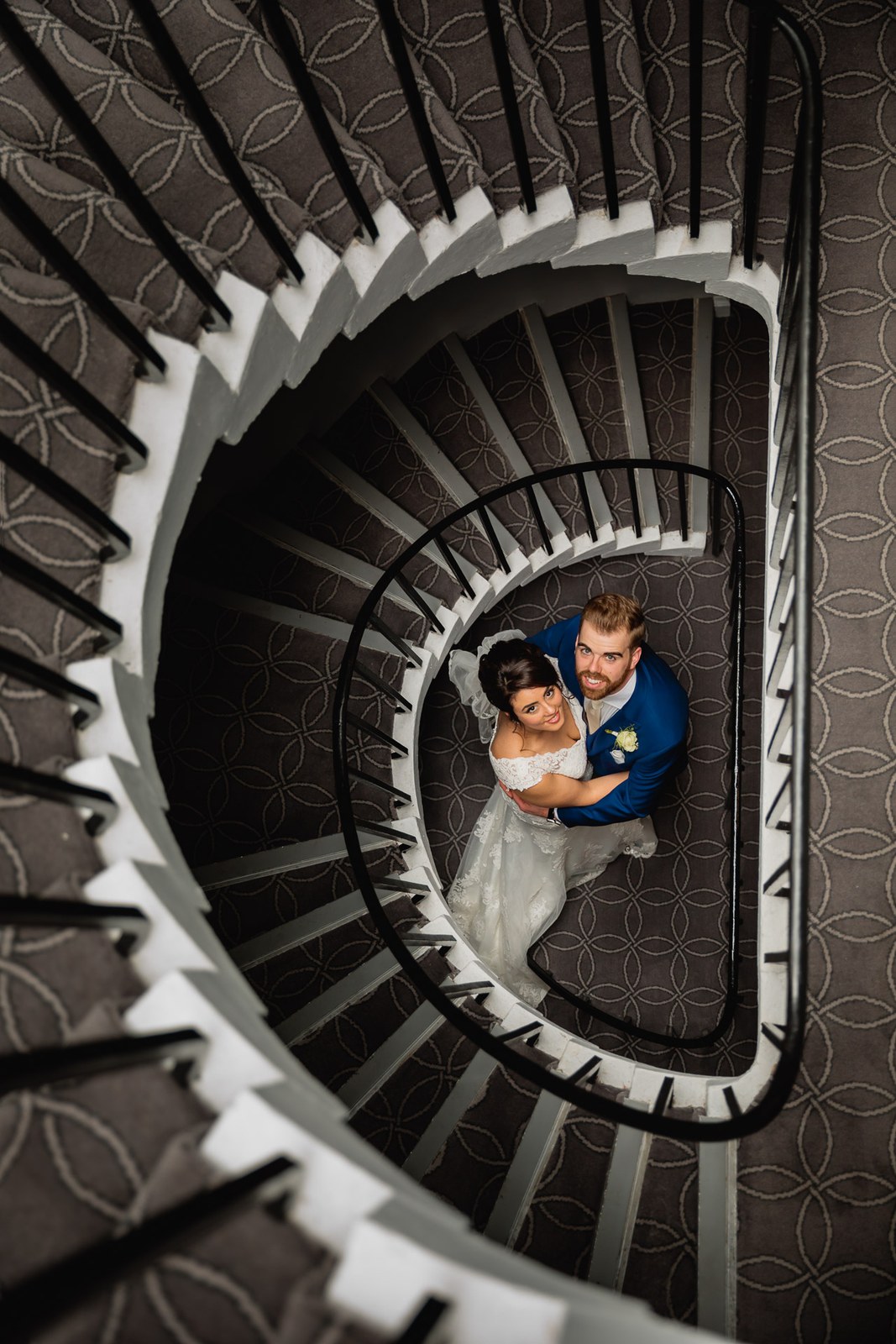 Overhead view down the spiral staircase at Villiers Hotel with the couple far below