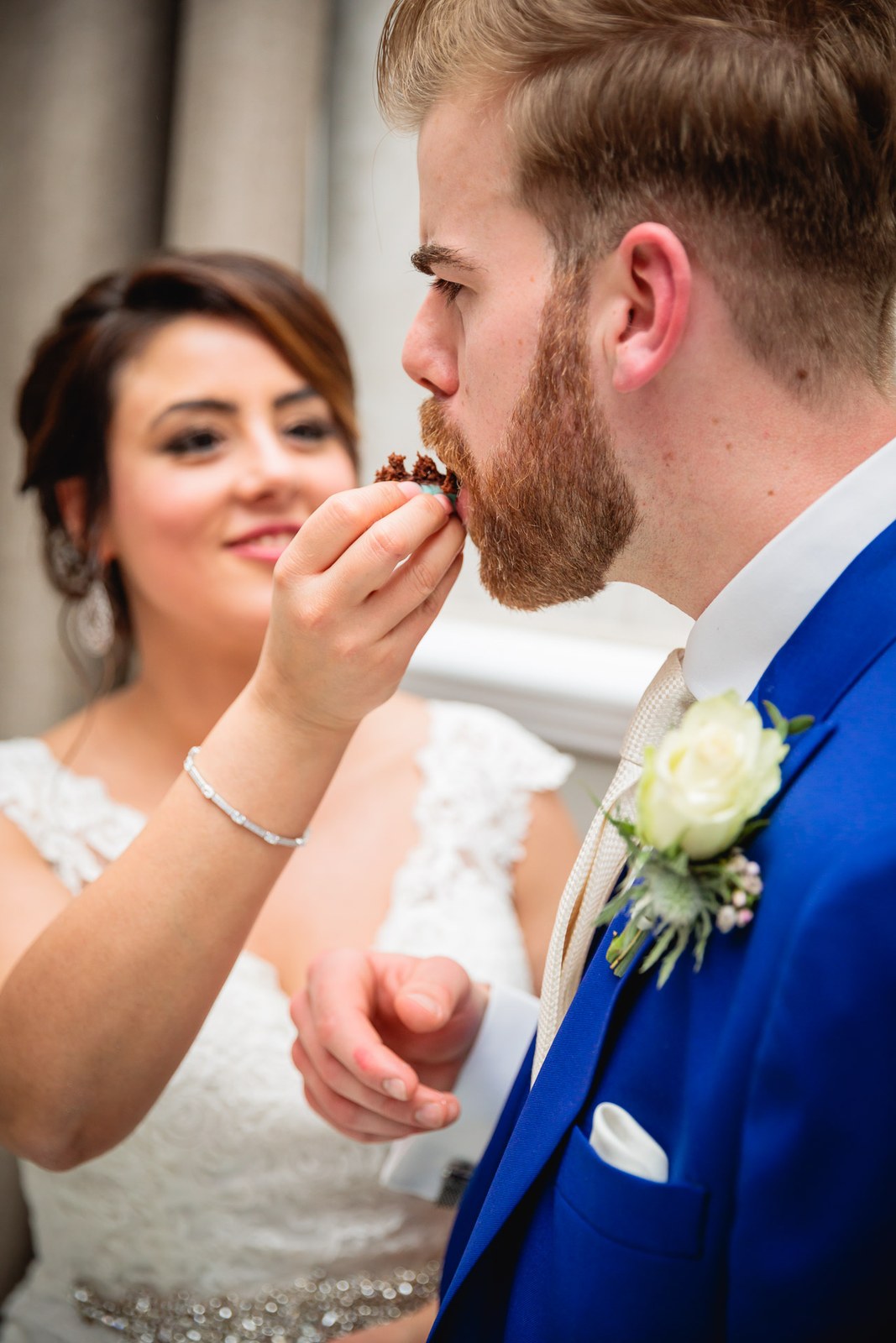 The bride feeding the groom a bite of wedding cake