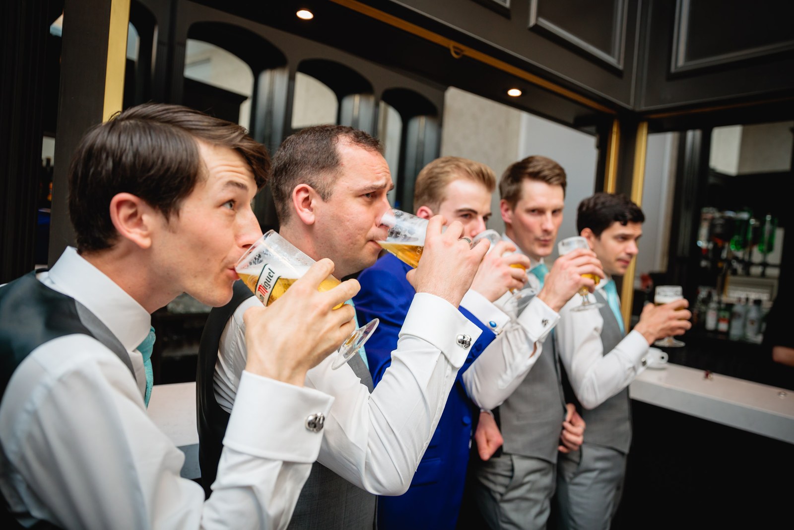The groom and his groomsmen downing pints together at the bar