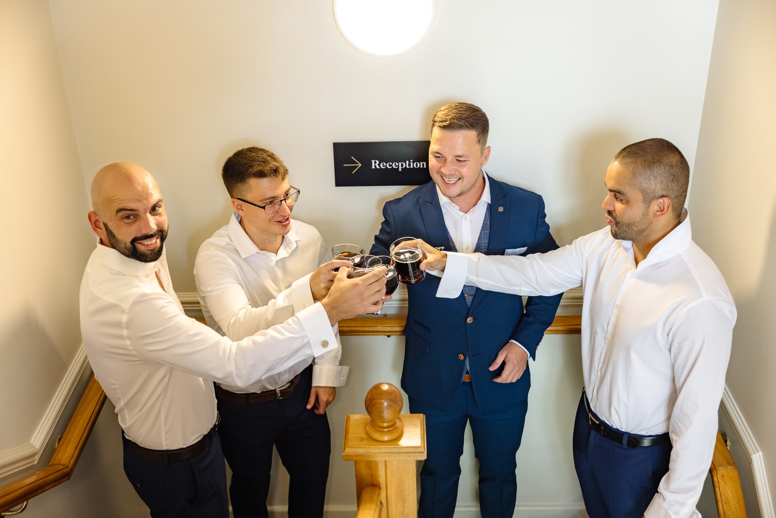 The groom and his groomsmen raising a celebratory toast before the ceremony
