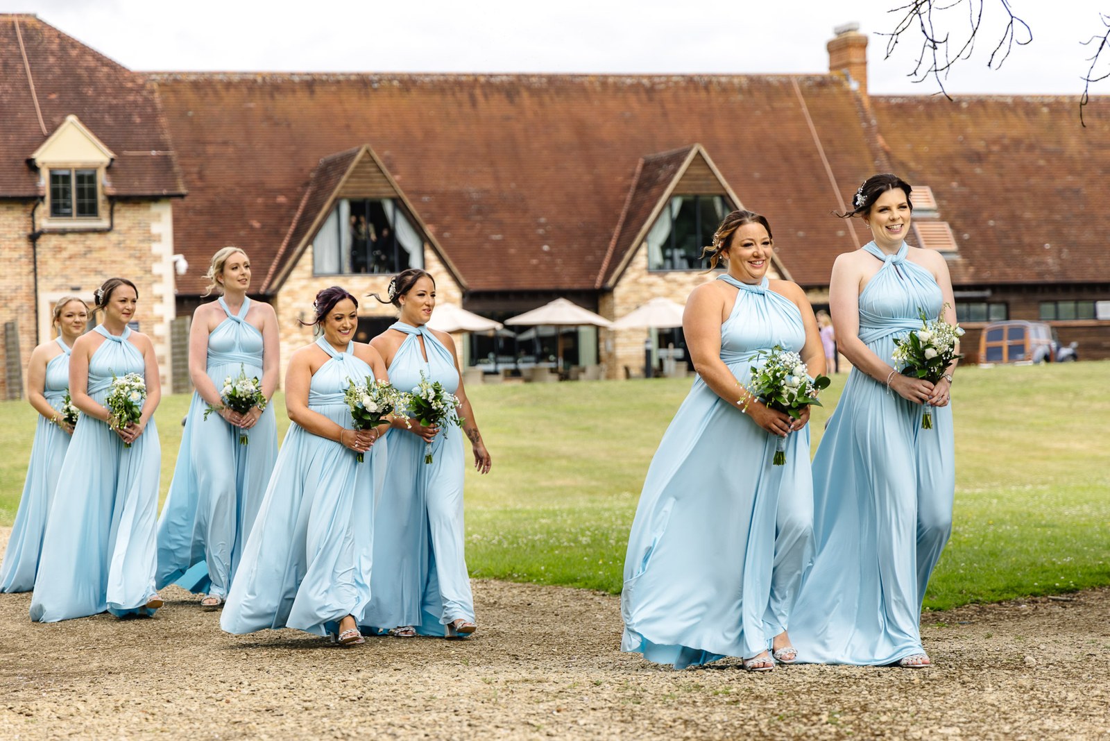 The stone-and-tile frontage of voco Oxford Thames behind the bridal party