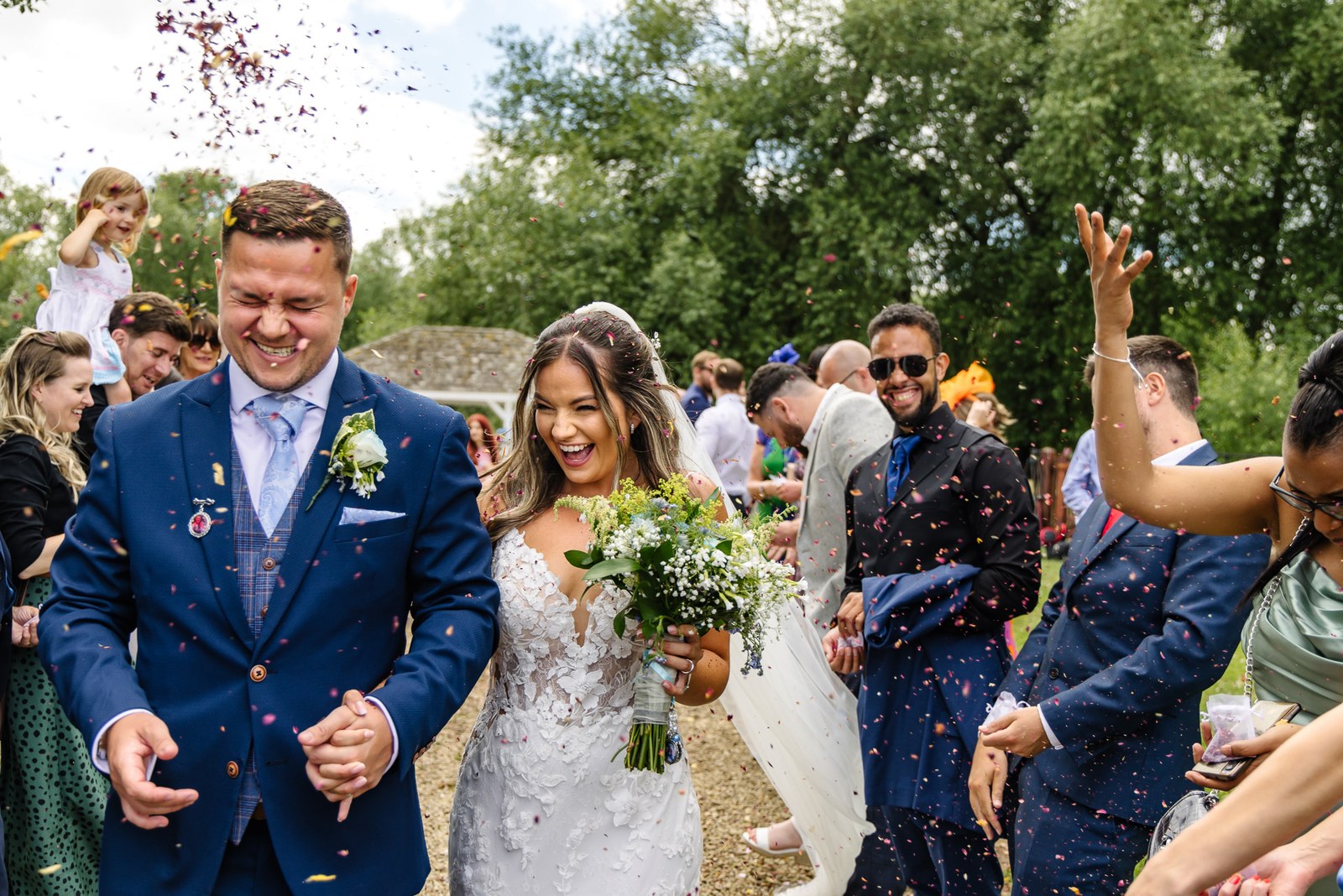 The couple showered with confetti by guests after the ceremony