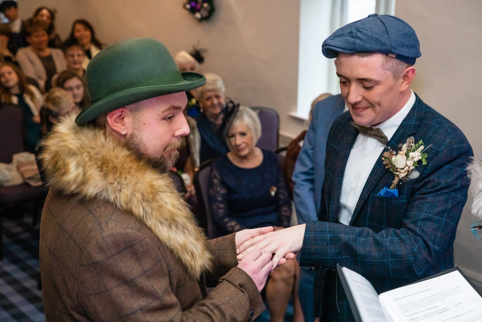 One groom placing the wedding ring on his partner's finger
