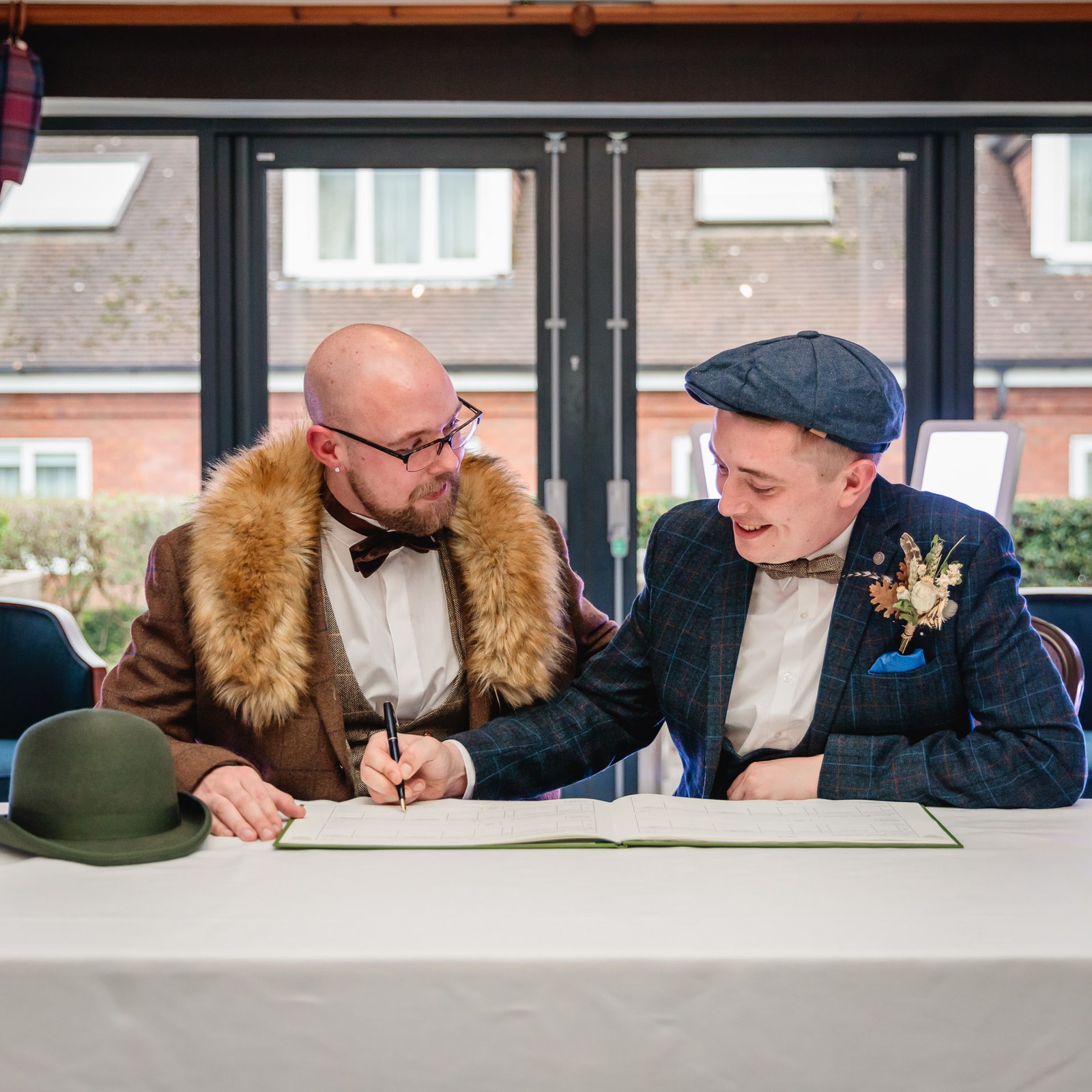 The two grooms signing the marriage register together