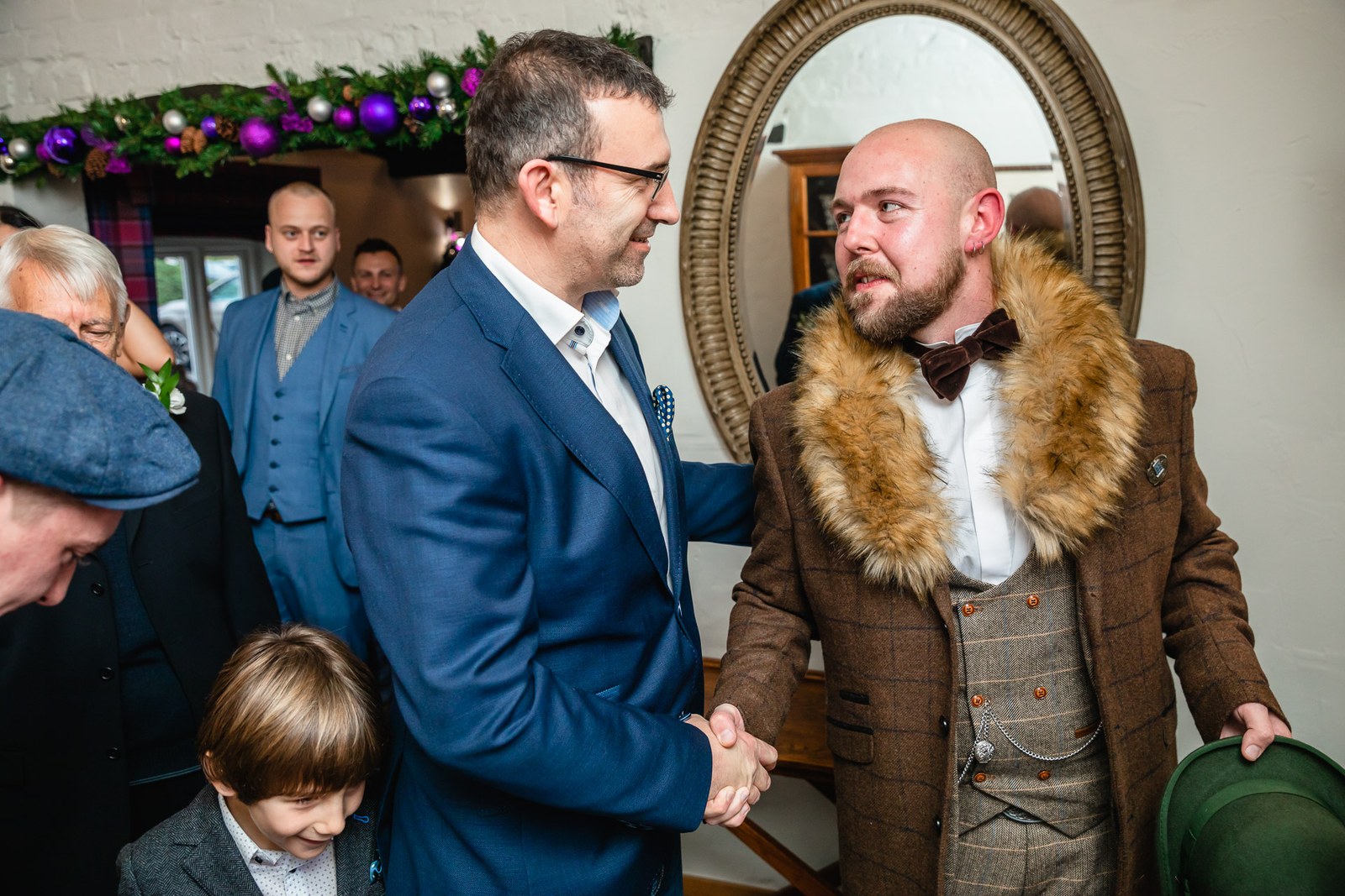 A groom congratulated with a warm handshake after the ceremony