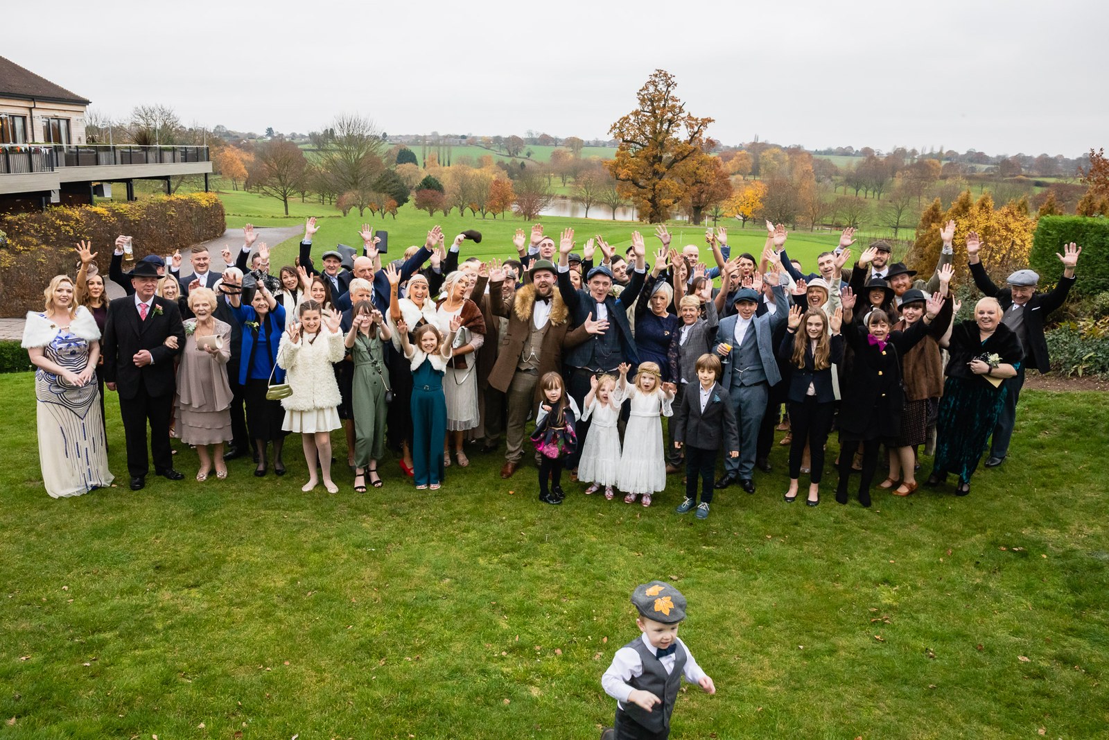 Group portrait of all the guests waving on the Windmill Village Hotel grounds