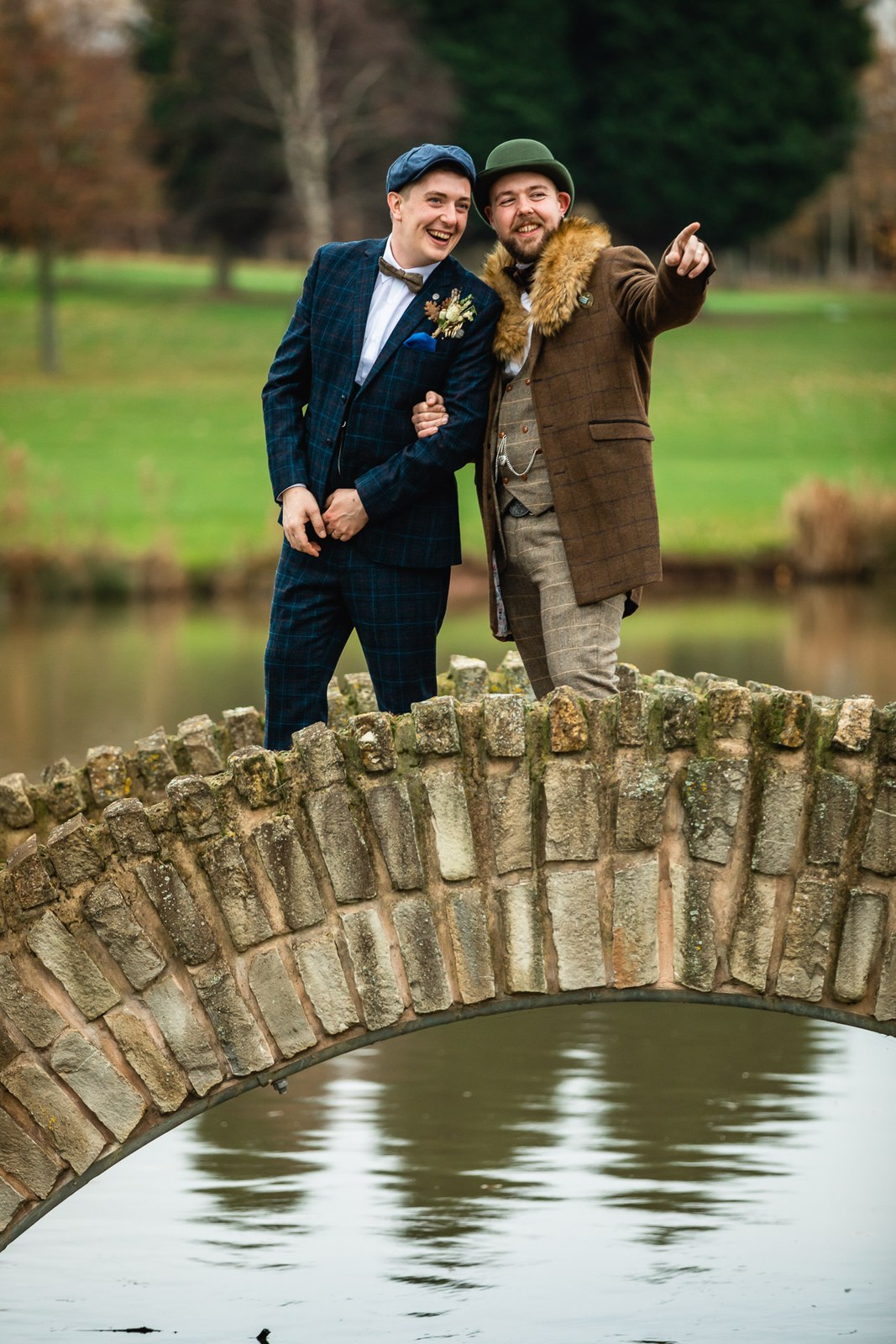 The grooms on the arched stone bridge across the Windmill Village Hotel lake