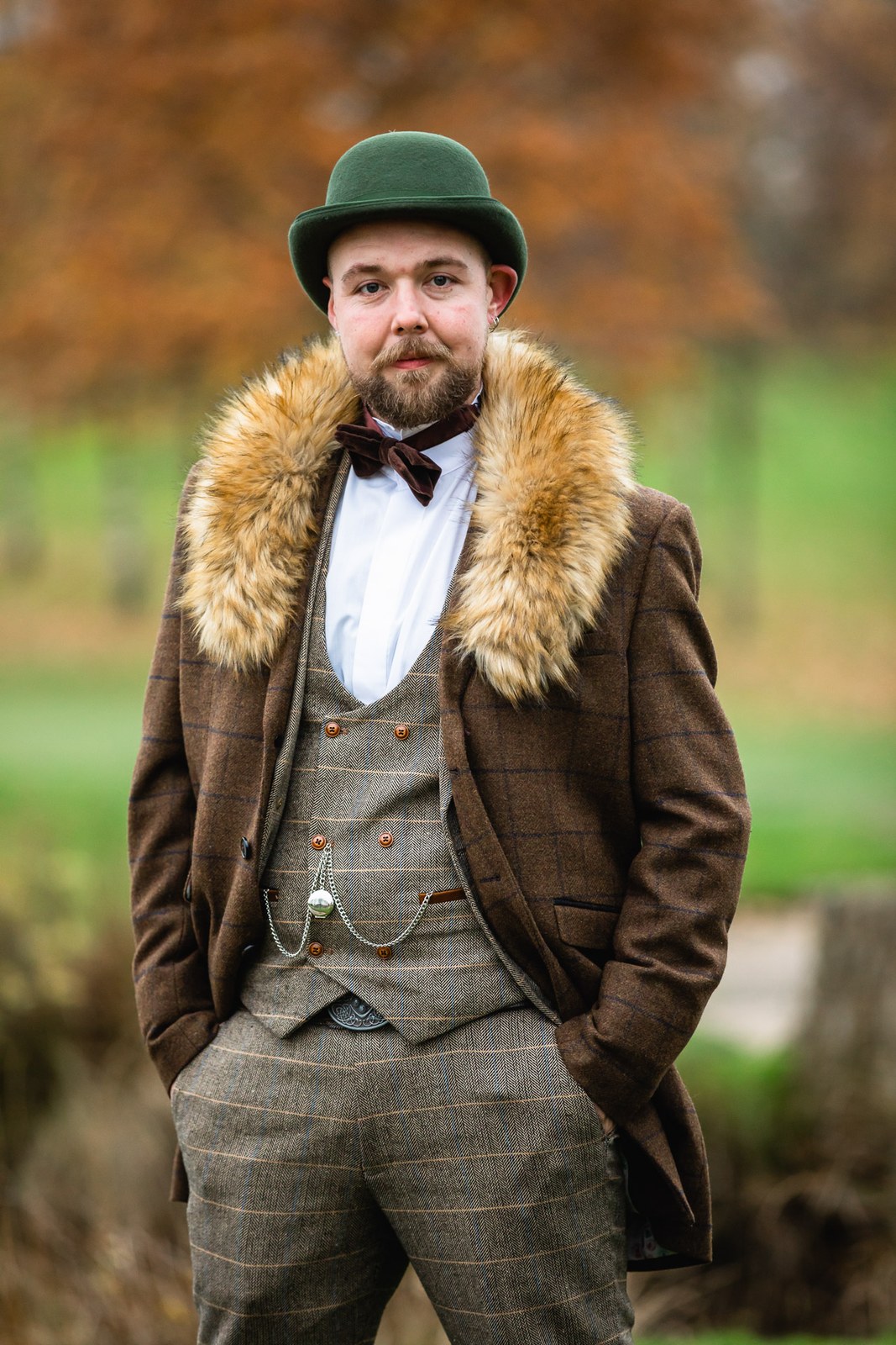 Portrait of a groom in tweed with a fur collar and green bowler hat