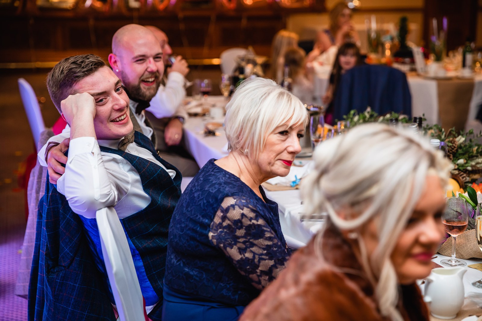 The grooms laughing together at the top table during the speeches