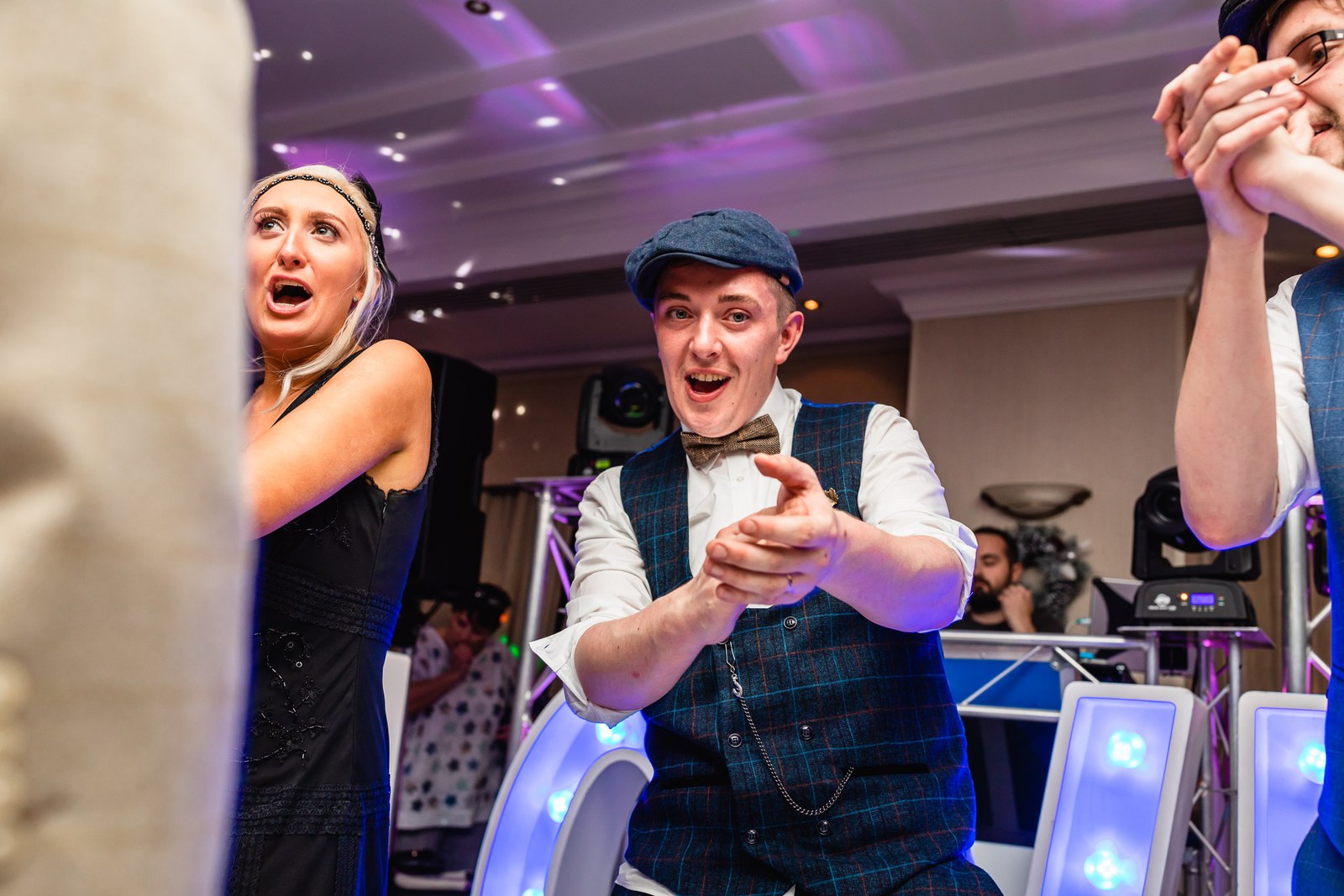 A groom dancing in the middle of the celebrating crowd