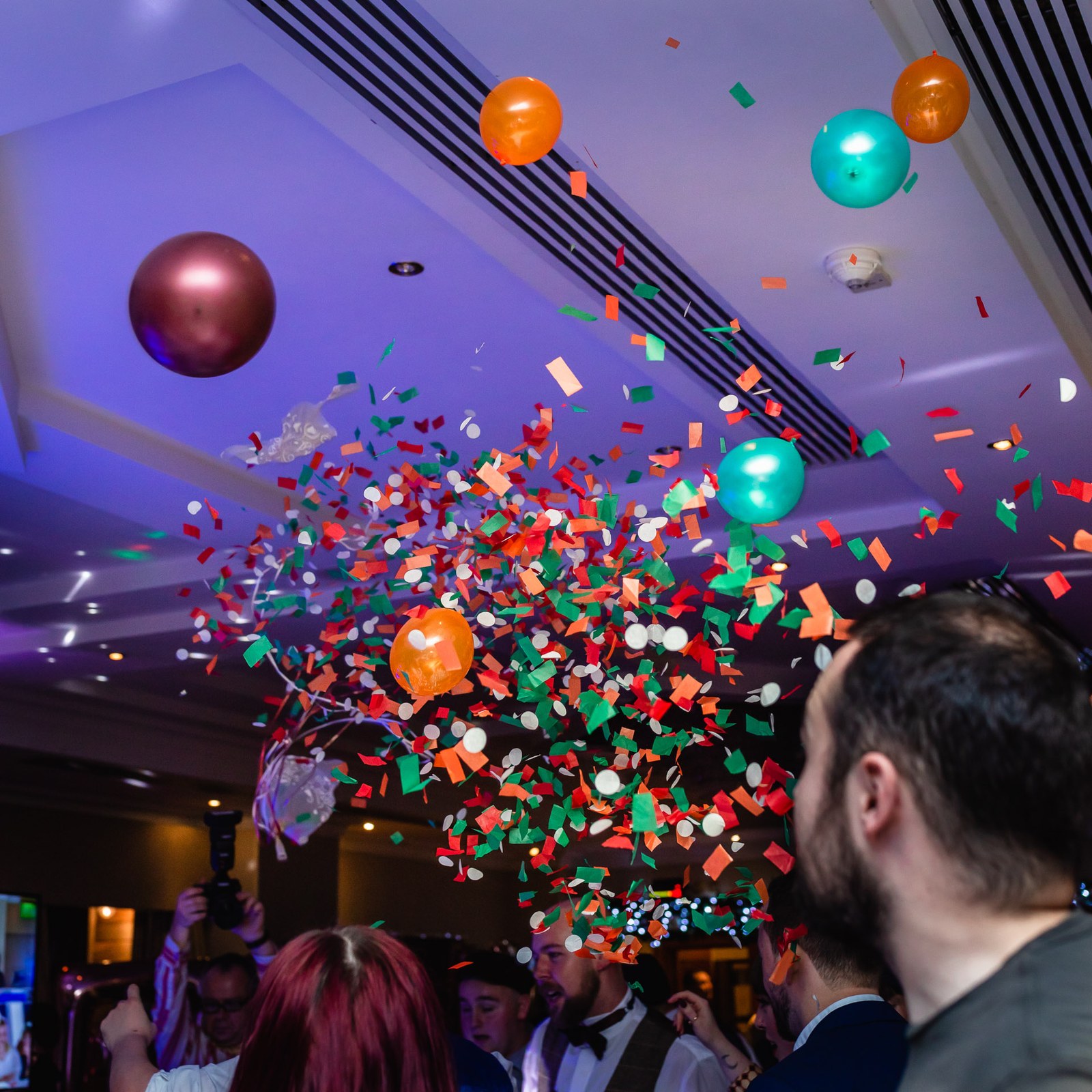 Confetti and balloons cascading over the dance floor