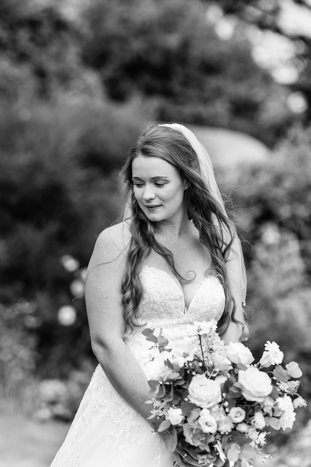 Black and white garden portrait of the bride holding her bouquet