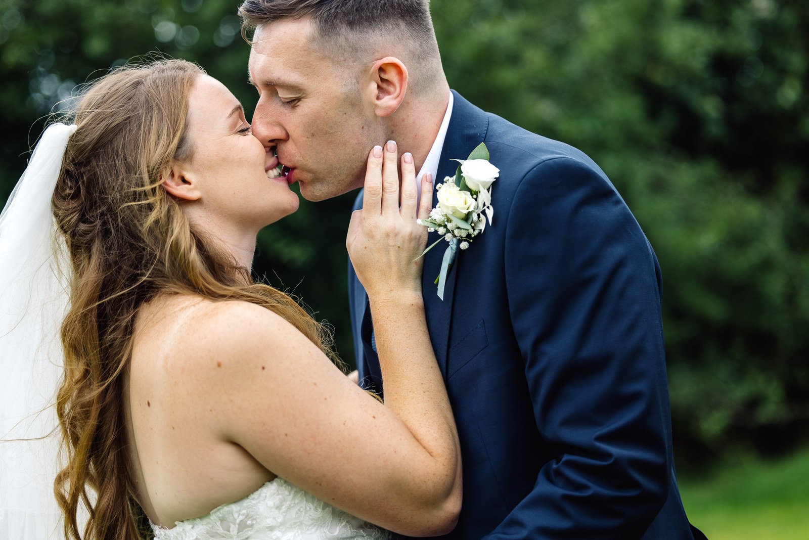 The newlyweds sharing a tender kiss out in the grounds