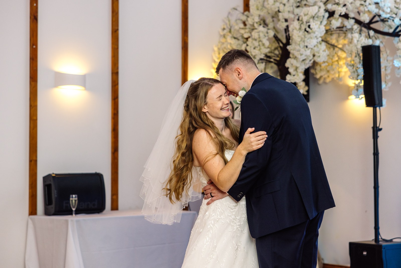 The couple's first dance beneath the blossom arch at Winters Tale Country Barn