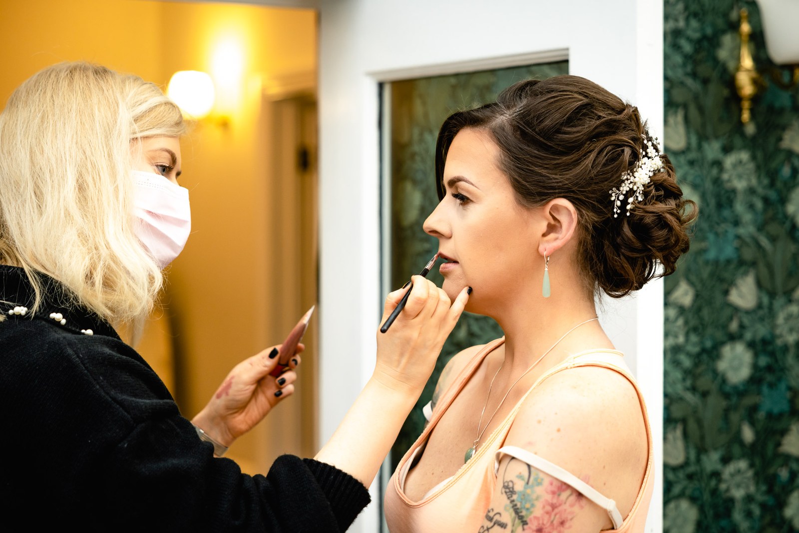 Bride having her make-up applied ahead of the ceremony