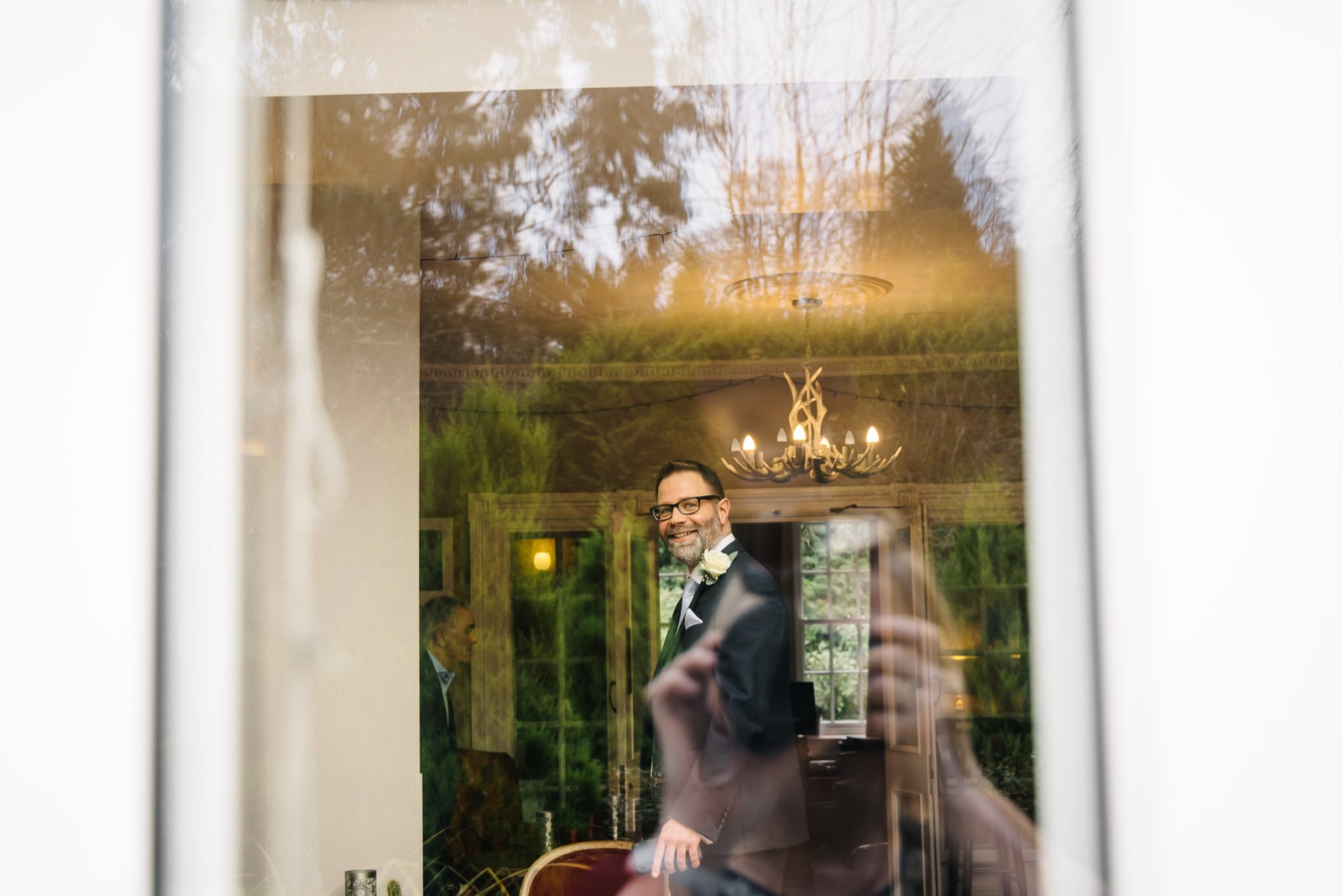 The groom glimpsed through a window in the ceremony room