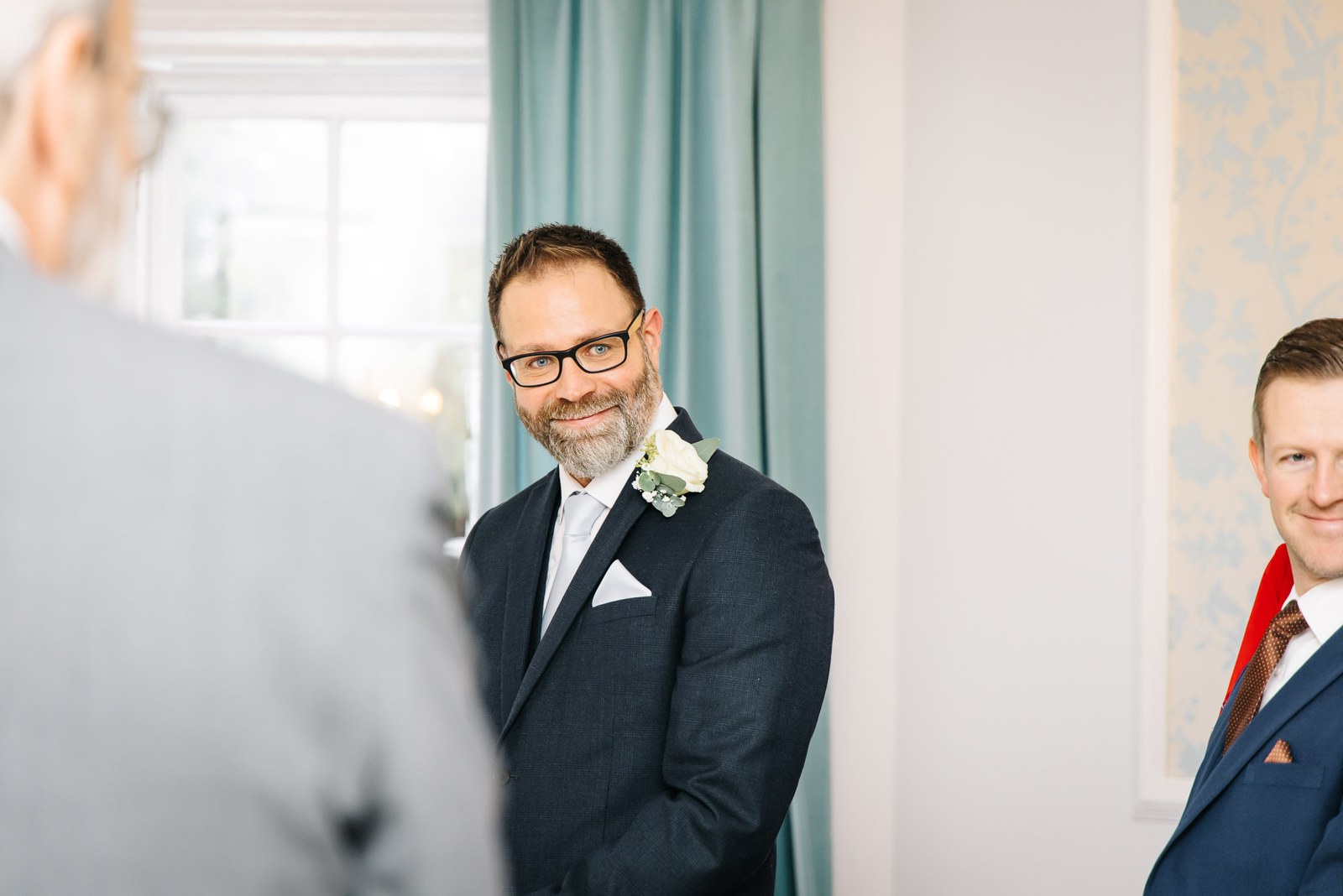 The groom waiting at the front as the guests gather