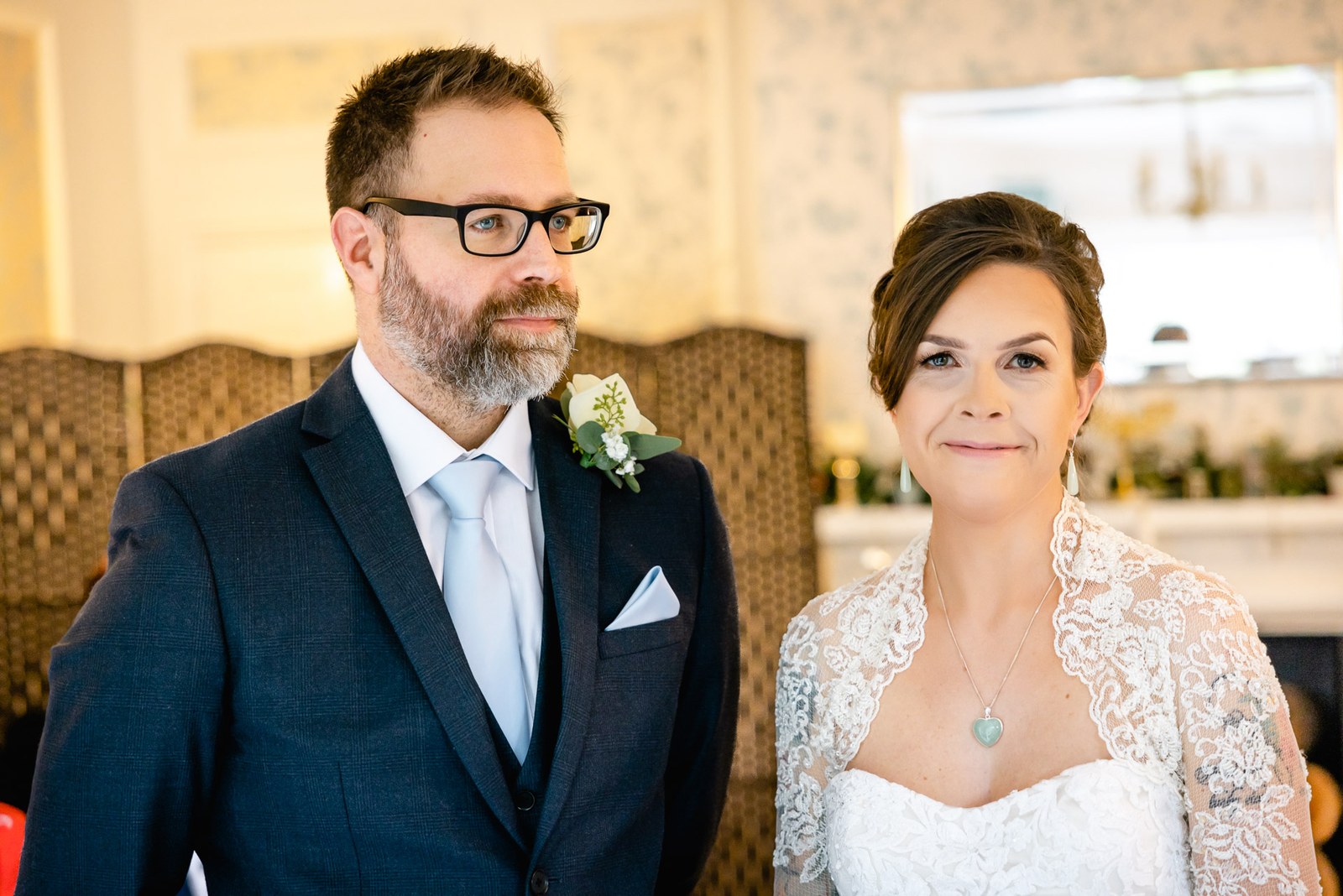The couple standing together at the front during their ceremony
