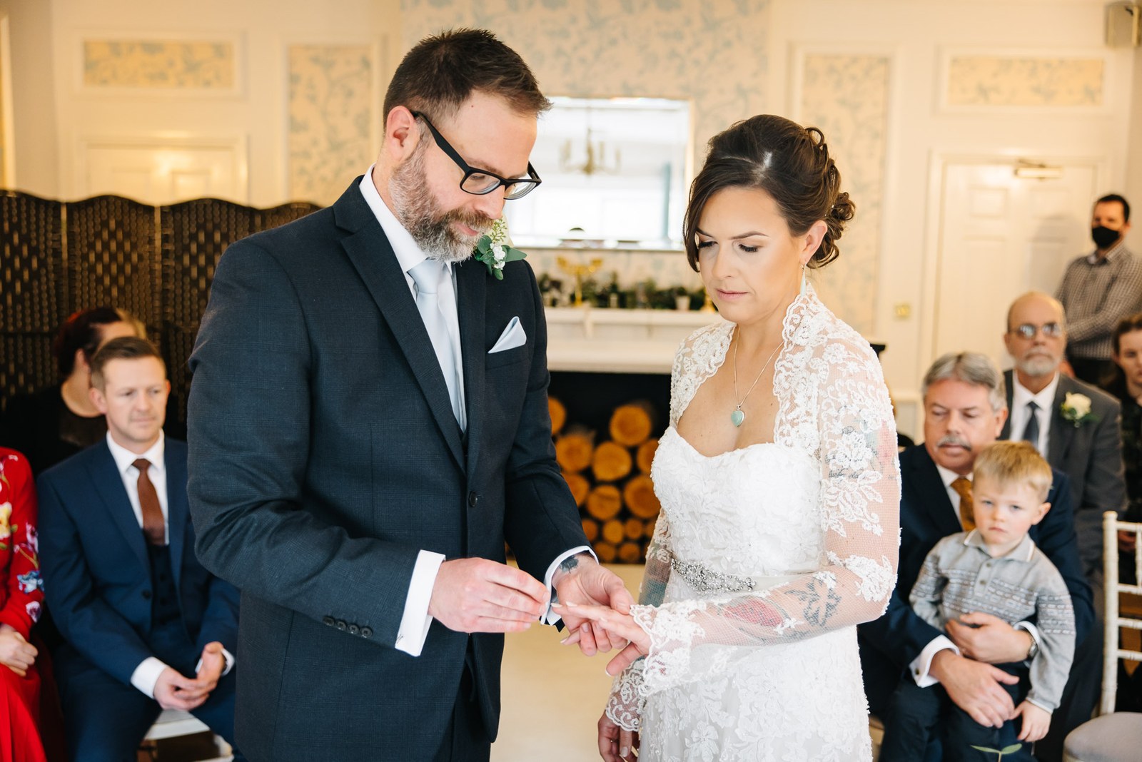 The groom placing the wedding ring on the bride's finger