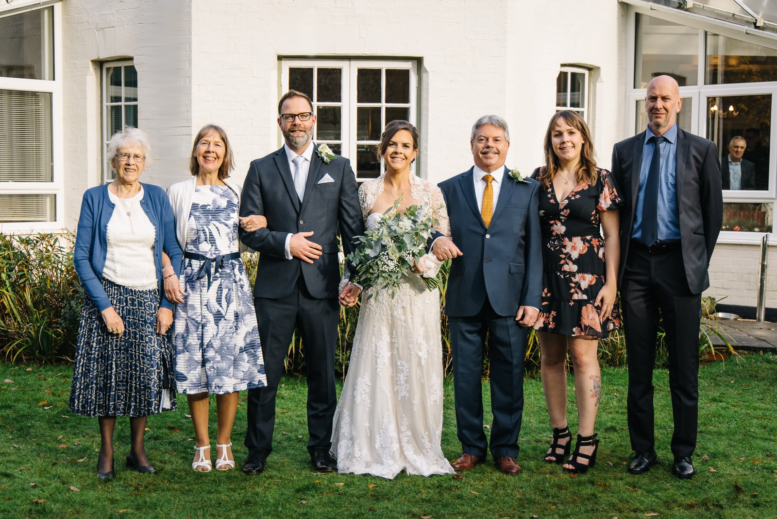 Family group portrait on the lawn outside Woodlands Lodge Hotel