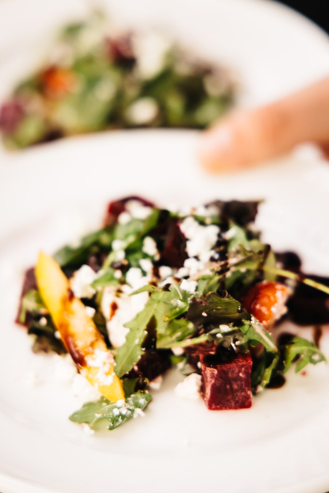 A plated beetroot and soft cheese salad starter