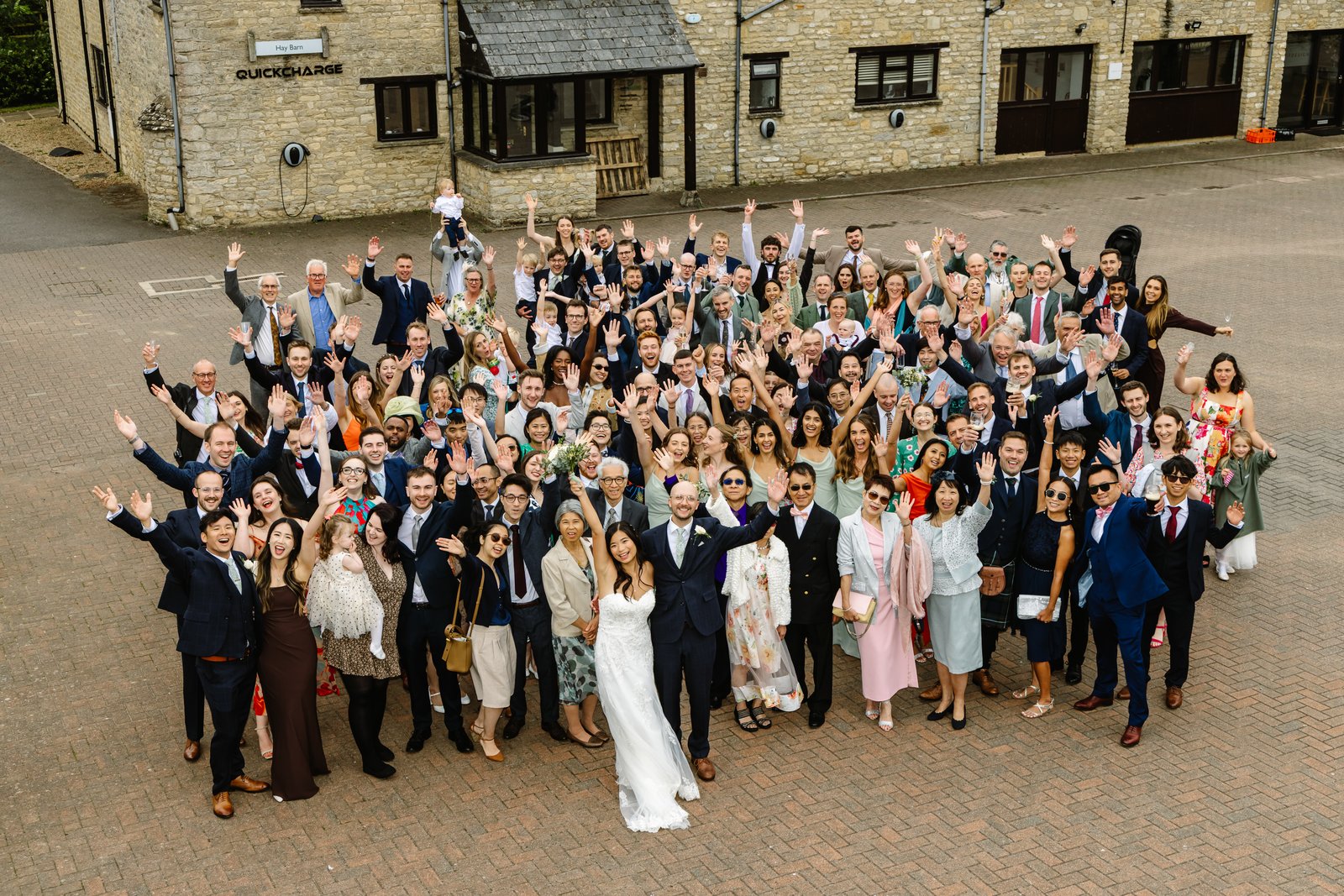 All the wedding guests gathered in the courtyard at Worton Hall, photographed from above.