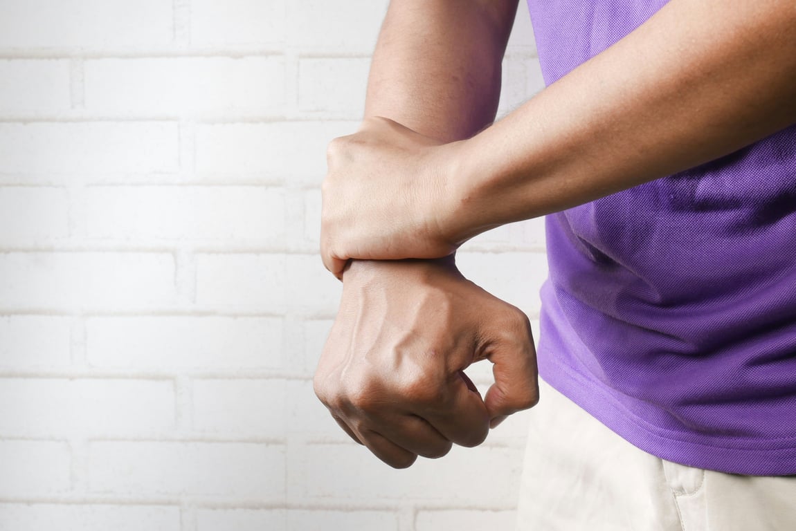 Man grabbing his wrist in pain