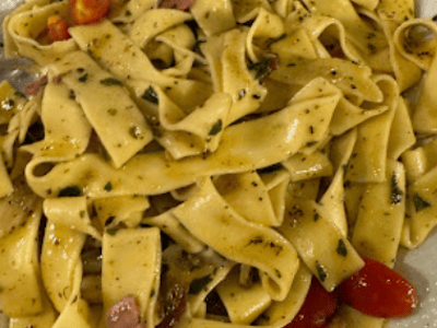 Fresh pasta filled with tomatoes and herbs, served at the Trattoria Piaceri e Tradizione, offering an authentic Italian dining experience.