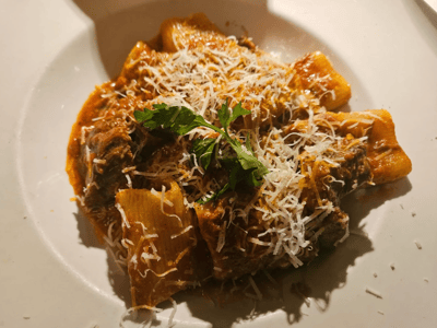 Rigatoni pasta in tomato sauce topped with parmesan cheese and coriander, served at La Masseria.