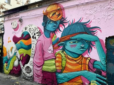 Colorful mural at Haus Schwarzenberg depicting stylized characters on a wall, illustrating vibrant urban culture.