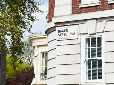 Plaque indicating Baker Street NW1, iconic for its association with Sherlock Holmes, in the Westminster district.