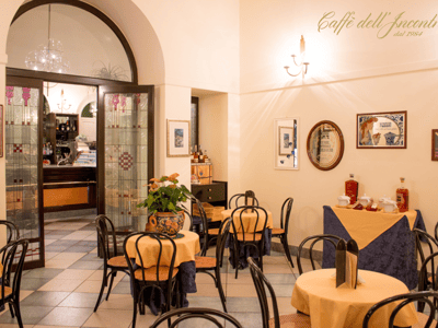 Warm atmosphere of Gelateria L'Incontro with yellow tables and a welcoming decor, perfect for enjoying ice creams.