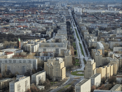 Aerial view of Karl Marx Allee, with its iconic buildings and tree-lined central avenue, illustrating Berlin's architecture.
