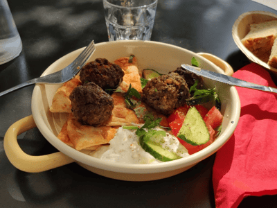 Delicious meatballs served with pita bread, fresh salad, and yogurt, Rises Delicacies, perfect for lunch.