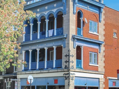 Historic building in Mile End, with an elegant blue balcony and colorful architectural details, representing the local heritage.