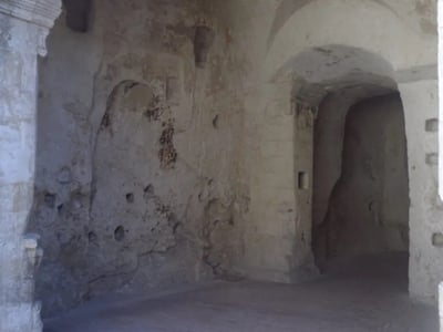 Cave historique de Palombaro Lungo, caractérisée par ses murs en pierre et ses ouvertures fascinantes.