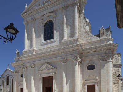 Neoclassical facade of the Chiesa Madre di San Giorgio, highlighting its architectural details in Chiesa Madre, Italy.