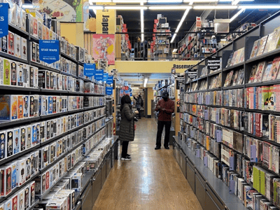 Shelves of collectibles and comics in the BOOKOFF store in New York, creating a lively and colorful atmosphere.