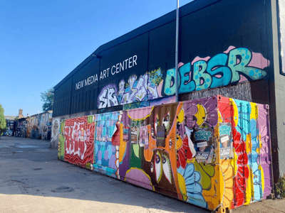 Colored graffiti wall at the New Media Art Center, showcasing the dynamic urban art of the local scene.