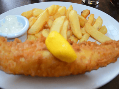 Crispy fish fillet served with golden fries and tartar sauce, served at Sea Shell in Lisson Grove.